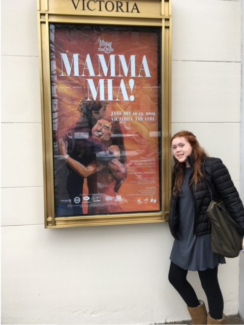 Allie in front of Mamma Mia poster at Victoria Theatre