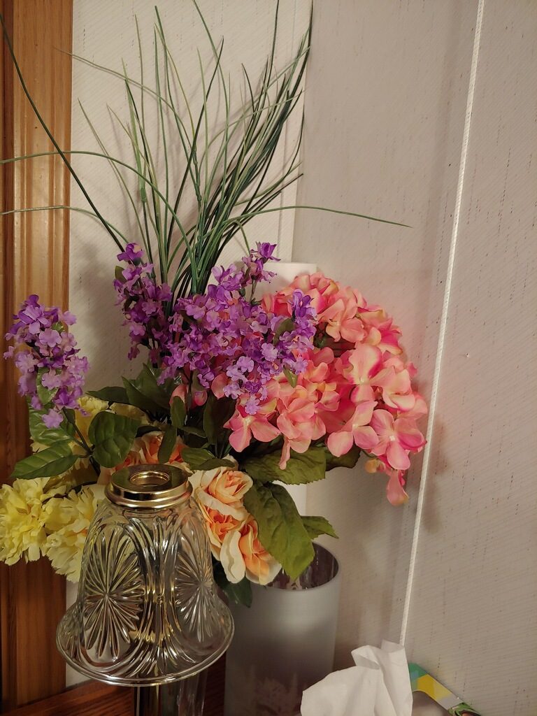 Photo of multi-colored purple, pink, and yellow flowers in a vase