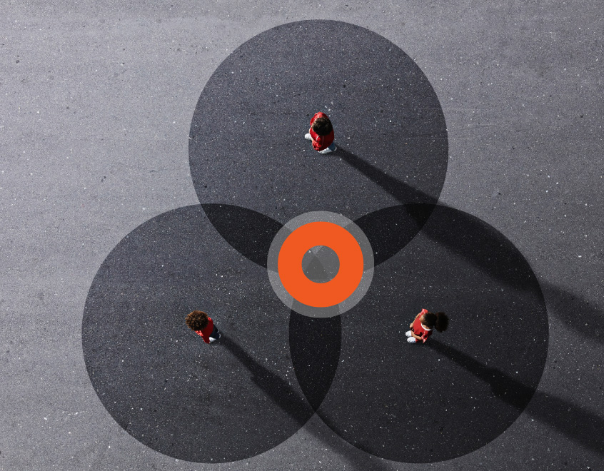 Aerial view of people on blacktop circles creating a venn diagram