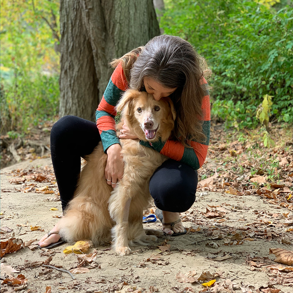 Ohlmann Group team member hugging dog